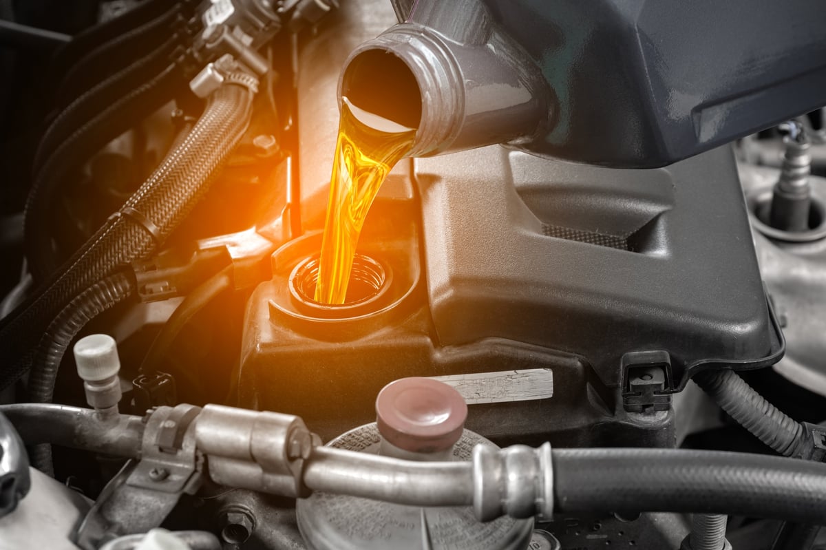 Refueling and pouring oil quality into the engine motor car Transmission and Maintenance Gear. Energy fuel concept