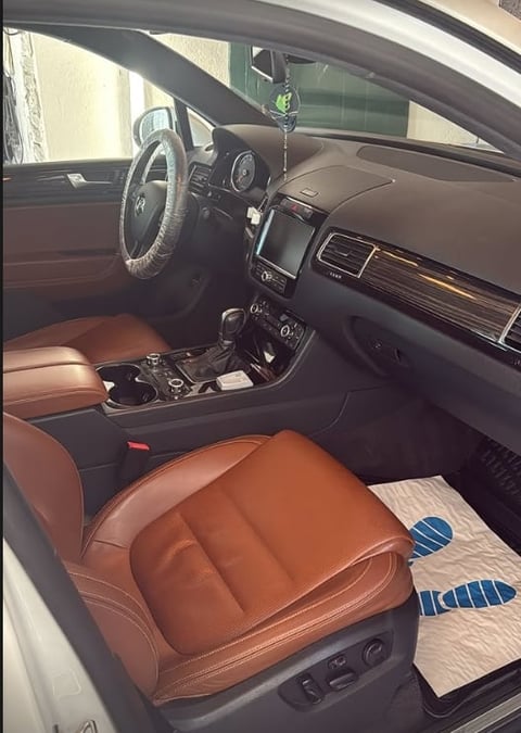 Car interior with brown leather seats and steering wheel